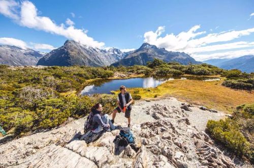 Fiordland-Walk-Routeburn-Track-two-walkers-on-rock