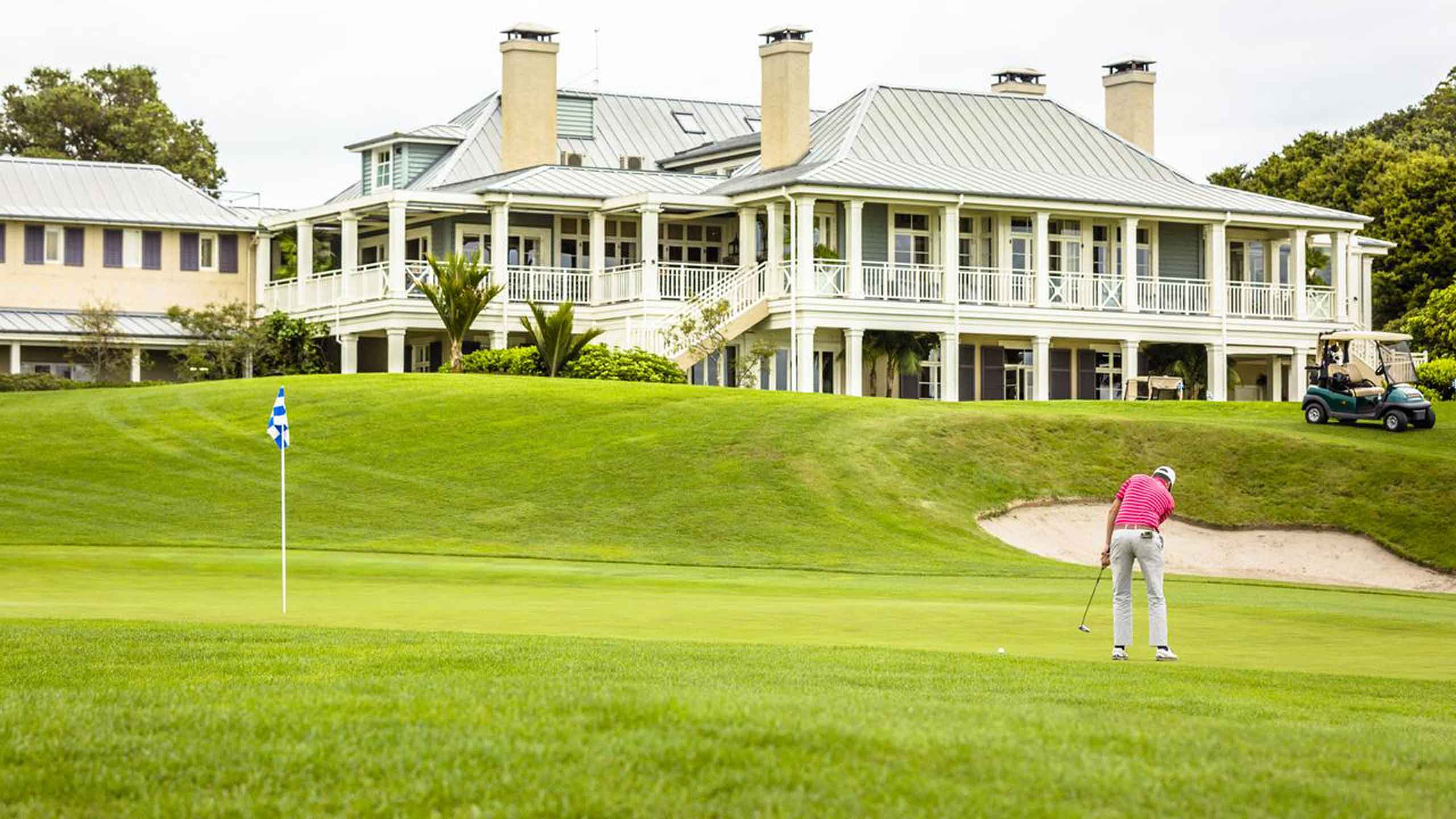 the-lodge-at-kauri-cliffs-bay-of-islands-new-zealand-exterior-and-golfer