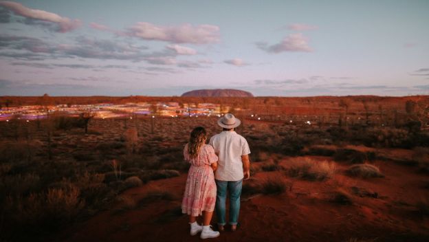 couple-watching-sunset-over-uluru-and-field-of-lights